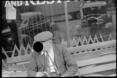 0486_ Man on bench, cars in reflection ,