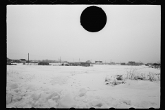 1371_Snowy landscape with distant housing.