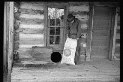 1431_Farmer with 100lb bag of Sunflower seeds ,  probably Tennessee