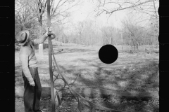 1625_Man examining a large metal bracket possibly for sign ,Tennessee