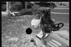 1649_Young boy in his pedal car and dog ,