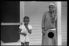 1717_Cheerful  African-American children outside their house