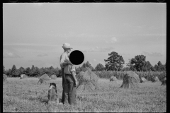 1868_Pride of harvest, hay stooks  farmer with son 