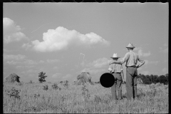 1873_Pride of harvest, hay stooks  farmer with son,