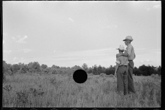 1875_Pride of harvest, hay stooks  farmer with son ,