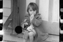 1908_Young girl sitting on doorstep . 