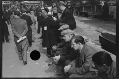 1936_Possibly unemployed sitting in line , New York City