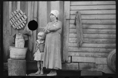 2444_ Rehabilitation client's wife and child  in the doorway of their home 