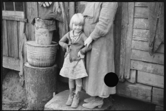 2448_Rehabilitation client's wife and child  in the doorway of their home