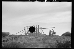 3503_ Pile of harvested corn, building unknown temporary wooden structure,