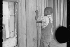 3525_Child of  sharecropper, playing primitive  violin made of stretched wire . Missouri.