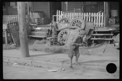 3686_Barefoot boy at front of houses , Charleston, West Virginia