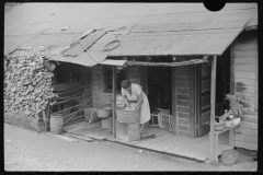 3731_Miner's wife washing clothes on front porch, Chaplin