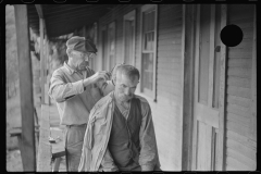 3888_  Haircuts on front porch. Chaplin, West Virginia