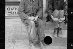 1451_Two poorly dressed men sitting in the street, Pikeville, Tennessee