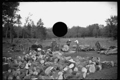 1495_Cutting logs for burning  , portable engine  rig, unknown location