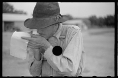 01548_Farmer with poor eyesight reading or making notes