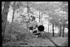 1613_Young boy climbing slender branch of tree