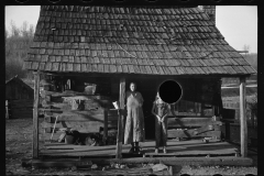 1629_Settlers standing in their woodshed , unknown location