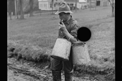 1827_Farmer with cans possibly for milk or animal feed ,unknown location