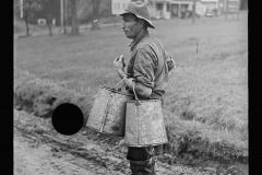 1828_Farmer with cans possibly for milk or animal feed ,unknown location