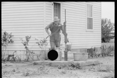 2018_Fetching a bucket of water from pump ( and well ) outside new build house