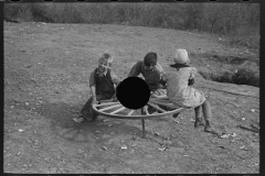 3045_Farm children playing on homemade merry-go-round. Williams County, North Dakota