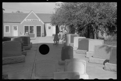 3379_Girl playing among tombstones, Lexington, Nebraska.  H L Lammers , monumental masons.