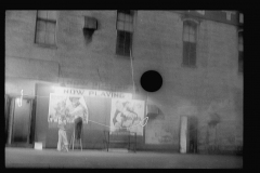 3395_Putting up movie posters at night, Washington, D.C
