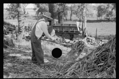 3451_Farmer working at sorghum mill, Lancaster County, Nebraska