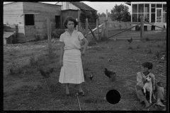 0049_Resettlement  farmers wife and son with dog