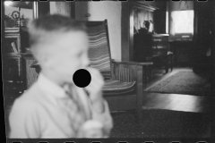 0477_well dressed boy unknown interior, possibly Nebraska