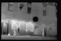 3395_Putting up movie posters at night, Washington, D.C