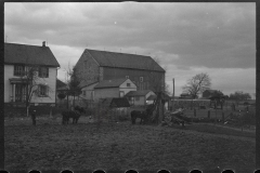 1220_Traditional ploughing behind houses , locational unknown