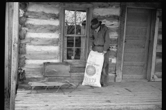 1431_Farmer with 100lb bag of Sunflower seeds , Unknown location