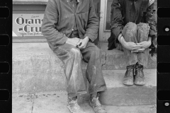 1451_Two poorly dressed men sitting in the street, Pikeville, Tennessee