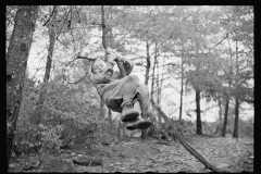 1613_Young boy climbing slender branch of tree