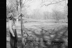 1625_Man examining a large metal bracket possibly for sign ,Tennessee