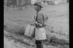 1828_Farmer with cans possibly for milk or animal feed ,unknown location