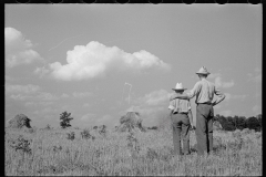 1873_Pride of harvest, hay stooks  farmer with son , unknown location.