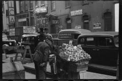 1940_Fruit vendor , possibly west 48th Street New City . Century Furniture store