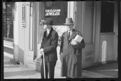 2480_ Two senior gentlemen, outside Theo Gahm Jeweler,  Main street