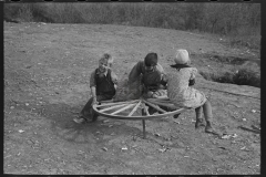 3045_Farm children playing on homemade merry-go-round. Williams County, North Dakota