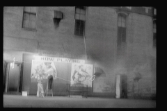 3395_Putting up movie posters at night, Washington, D.C