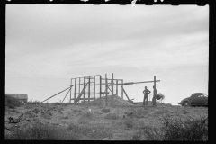 3503_ Pile of harvested corn, building unknown temporary wooden structure,