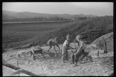 3714_Children playing in pile of sand, Tygart Valley, West Virginia