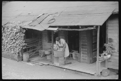 3731_Miner's wife washing clothes on front porch, Chaplin