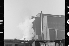 4033_Squatters' shacks with grain elevator in background