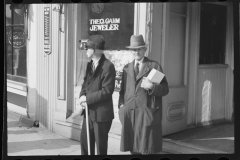 2480_ Two senior gentlemen, outside Theo Gahm Jeweler,  Main street