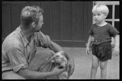 0085_Young resettled farmer with son